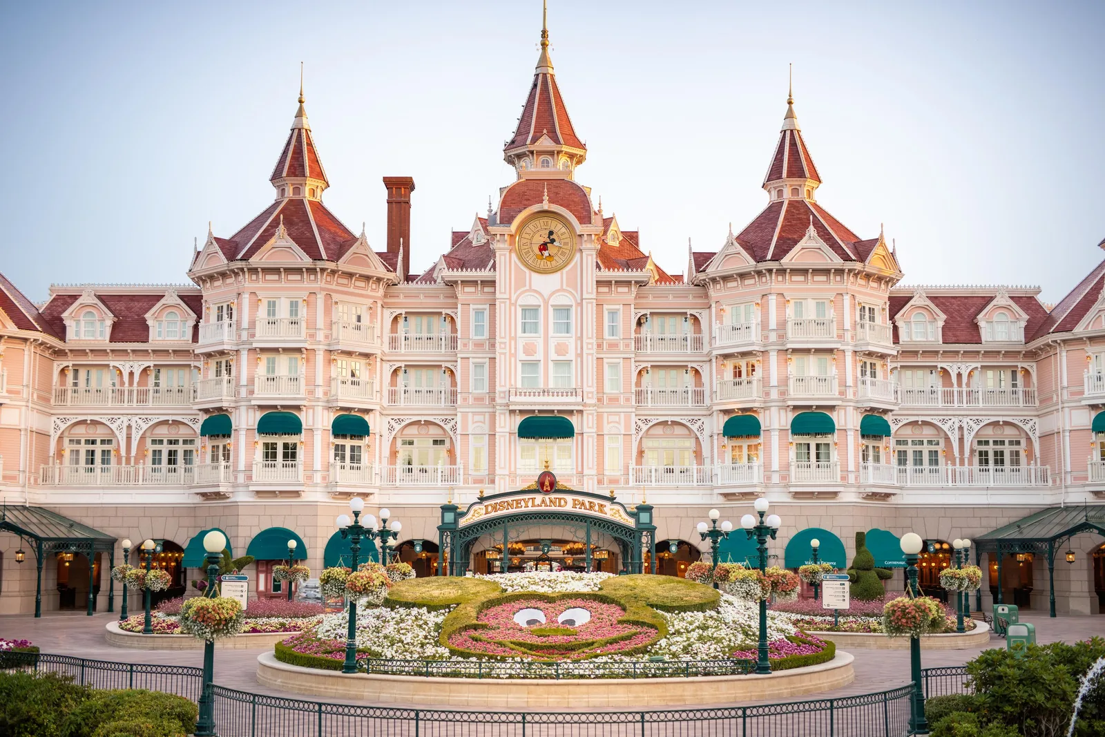 Het Disneyland Hotel boven de ingang van het Disneyland Park, met de bloemenfiguur van Mickey ervoor